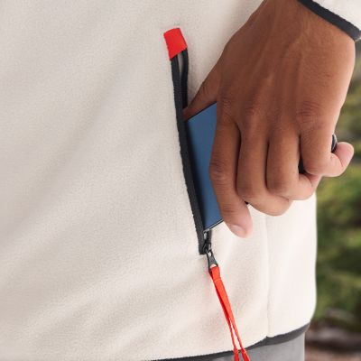 Model placing a phone into the zippered hand pocket.