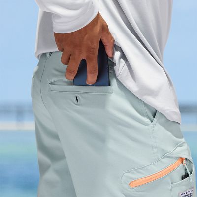 Model placing a phone into the back pocket.