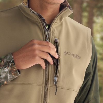 Model placing keys into the chest zip pocket.