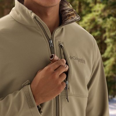 Model putting duck whistle into zippered chest pocket.