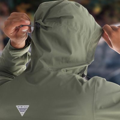 Close-up of a model adjusting the drawstring on hood.