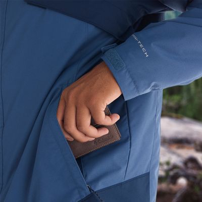 Model putting wallet in hand pocket.