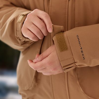 Close-up of a model adjusting the cuffs to their perfect fit.