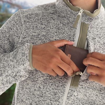 Close-up of a model pulling the drawcord on the adjustable hem.