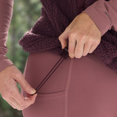 Close-up of a model pulling the drawcord on the adjustable hem.