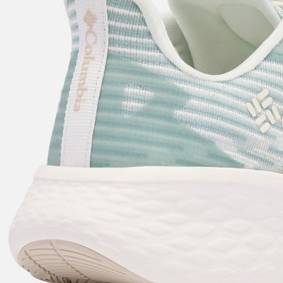 Close-up of a model's feet as they run through a forest landscape.