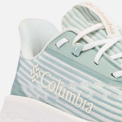 Close-up of a model tying the laces of their running shoes.