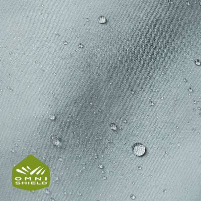 Close up of fabric with the Omni Shield logo in the bottom left and a graphic showing how moisture beads on the fabric's surface.