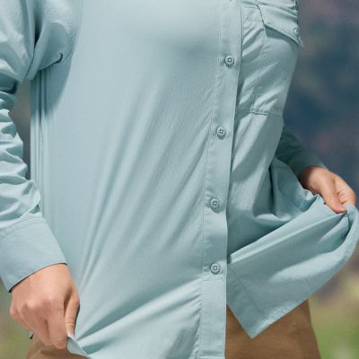 Close-up of a woman buttoning a Silver Ridge shirt. 