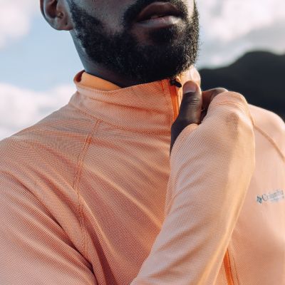 Close-up of a model zipping up their collar.
