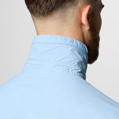 Close-up of a woman buttoning a Silver Ridge shirt. 