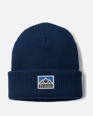 A tan baseball hat with a mountain logo on the front.