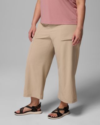 Waist-down image of a woman wearing green shorts and sandals.