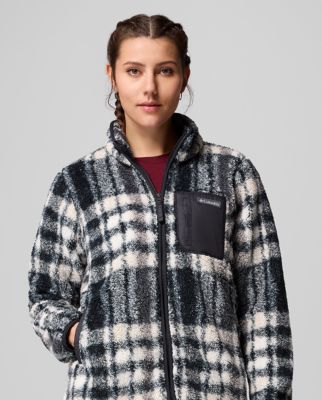 A woman wearing a plaid fleece zip-up jacket.