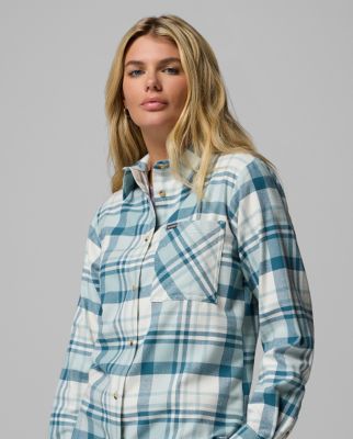 Woman wearing a pink button-up shirt.