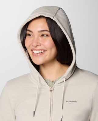 Woman wearing a light green sun hoodie.