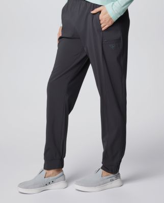 Waist-down image of a woman wearing grey shorts and sneakers.