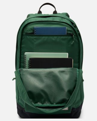 A back view of a person wearing a blue backpack.