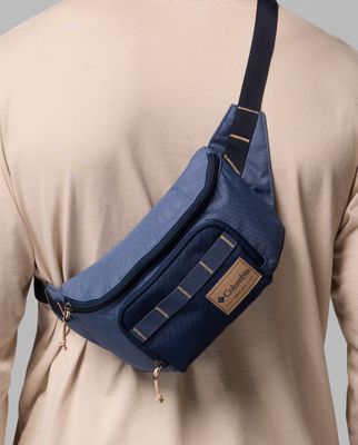 A person wearing a black hip pack as a crossbody.