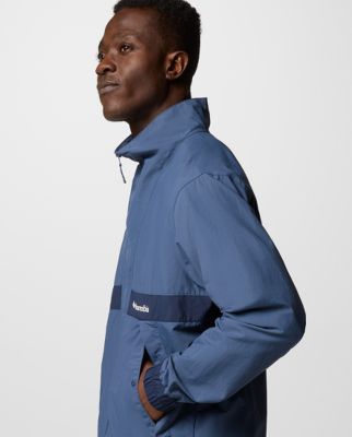 A man wearing a multi-color jacket.