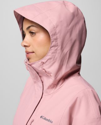 A woman wearing a teal rain jacket.