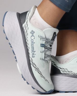A white trail running shoe.