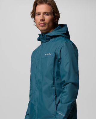 A woman wearing a teal rain jacket.