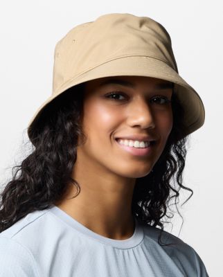 A woman wearing a tan bucket hat