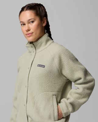 A woman wearing a light green fleece jacket.
