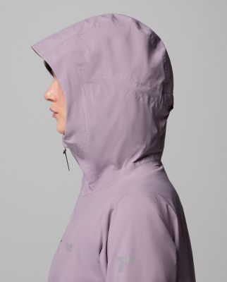 ⁨Woman wearing a purple rain jacket.