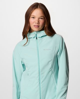 A woman wearing a teal softshell jacket.