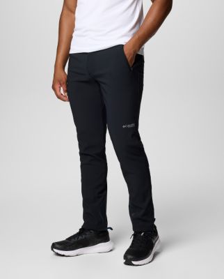 Waist-down image of a man wearing black pants and sneakers.