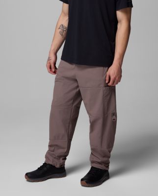 Waist-down image of a man wearing brown pants and sneakers.