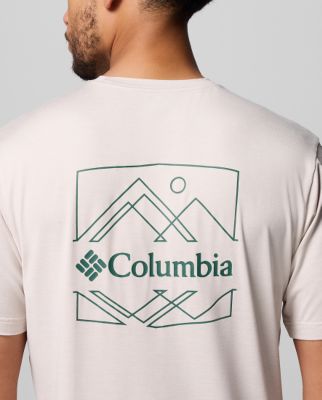 Man wearing a white t-shirt with a mountain graphic.