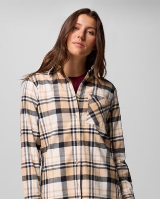 Woman wearing a pink button-up shirt.