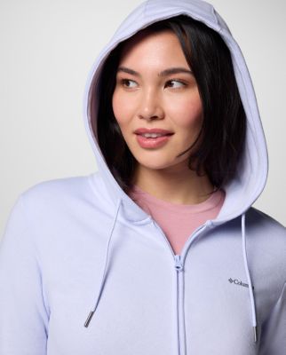 Woman wearing a light green sun hoodie.