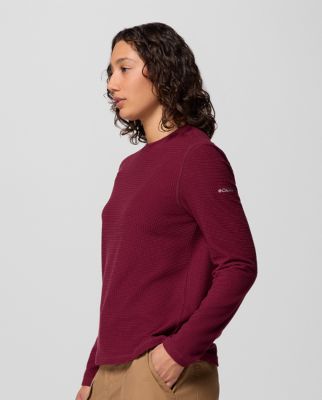 Woman wearing a purple long sleeve shirt.