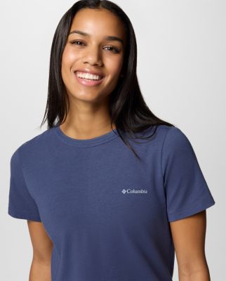 Woman wearing a pink tank top with a graphic on the front.white short sleeve shirt.