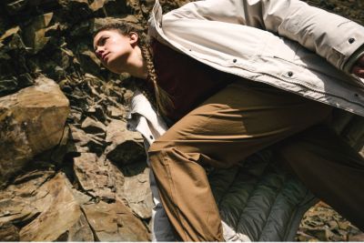 A woman hiking among rocks in the ROC pants.