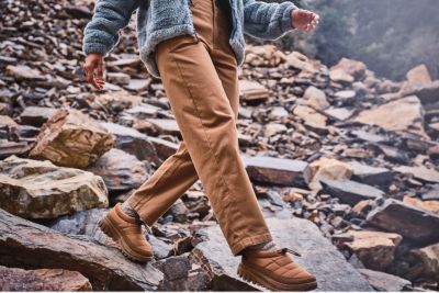 A woman hiking among rocks in the ROC pants.