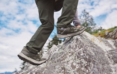 Scaling a steep boulder is no challenge for this person, thanks to Columbia's shoes with soles inspired by goat's hooves.