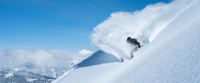  A backcountry skier carves a turn in deep powder snow.
