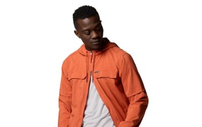 A man wears a bright orange zippered jacket.