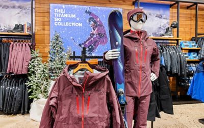 Interior of a Columbia retail space with a mannequin dressed in snow gear and racks of clothes. 