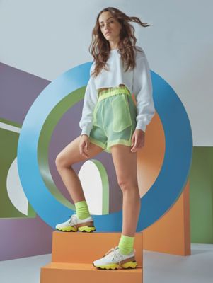 Woman wearing new Kinetic Impact sneaker posing