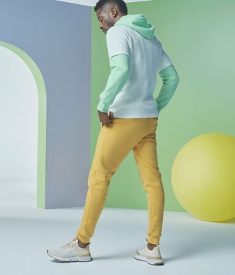 Man posing while wearing Kinetic Rush sneakers