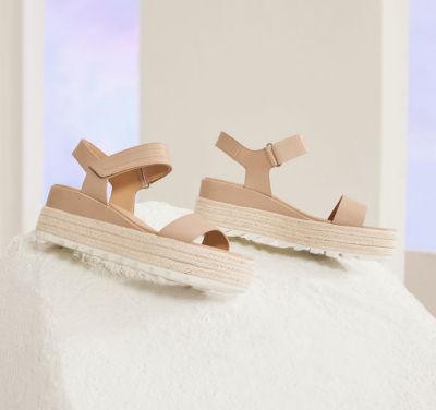 A pair of Cameron Flatform sandals on an beige background