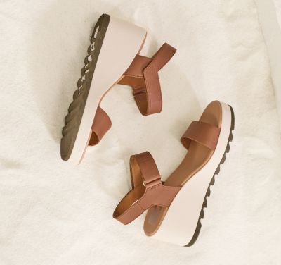 An Cameron Wedge sandals  on a beige background