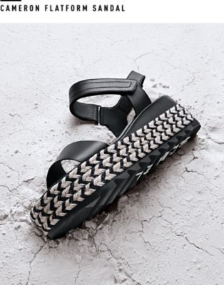 A Cameron Flatform sandal on a sand white surface.