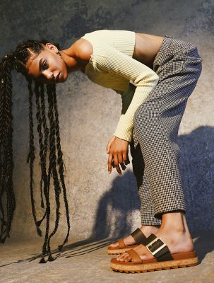 Monique Jones wearing Roaming Buckle Slide sandals